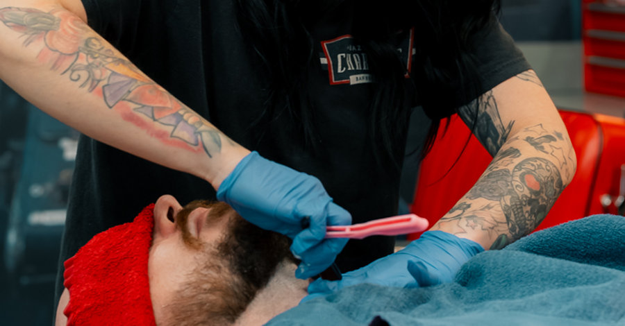 man in chair getting a shave